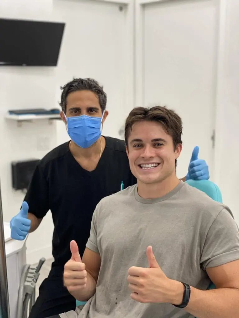 At Gramercy Orthodontics in New York, NY, Dr. Barry Elaahi, DDS, and a patient give thumbs up and smile from the dental chair.