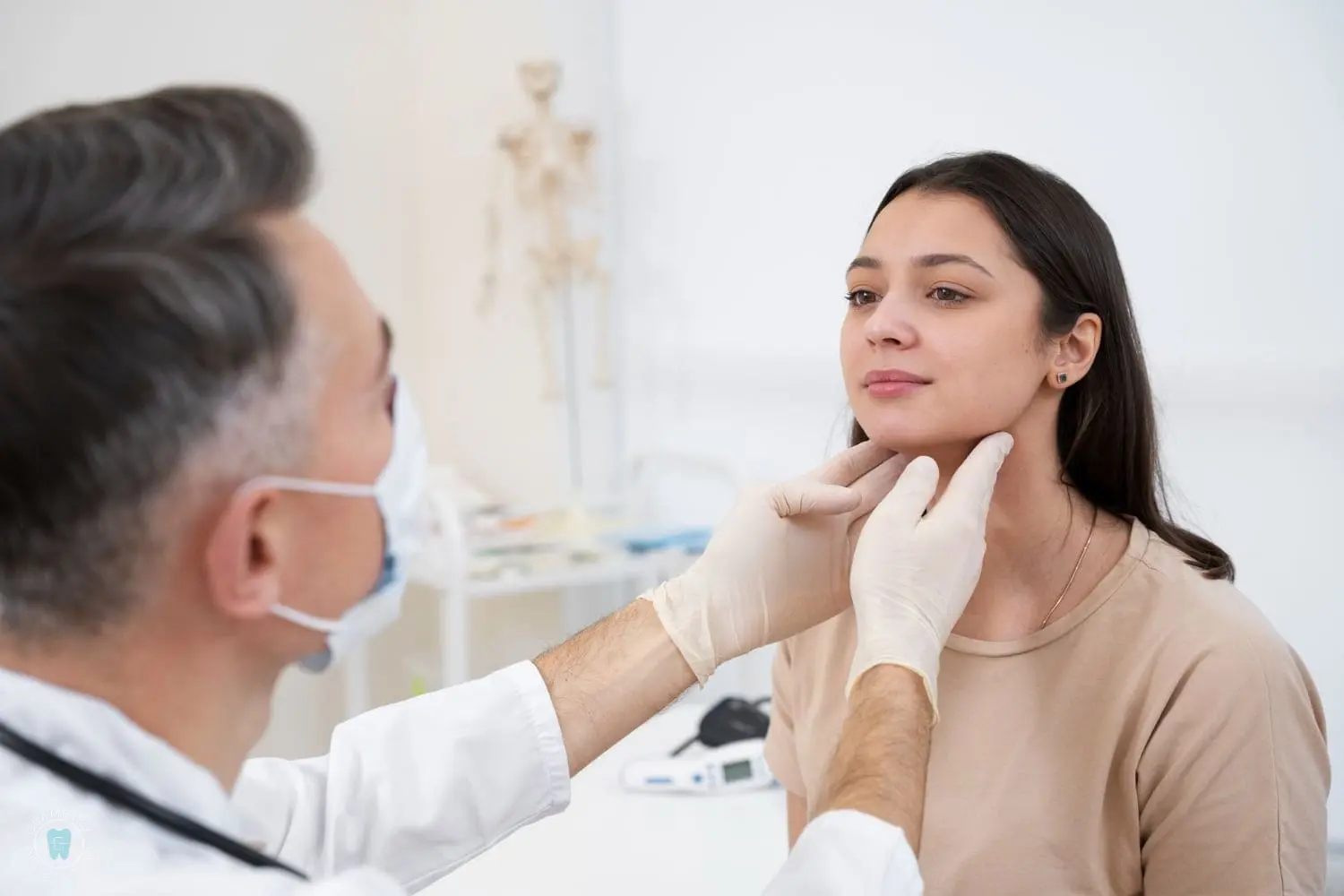 A doctor wearing gloves and a mask carefully examines a woman's neck in a medical office, discussing potential jaw surgery. The woman sits facing the doctor, intently listening to the options being presented in NYC