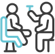 Two outlined figures face each other. One is seated, holding out an object, possibly a tool or device, towards the standing figure.