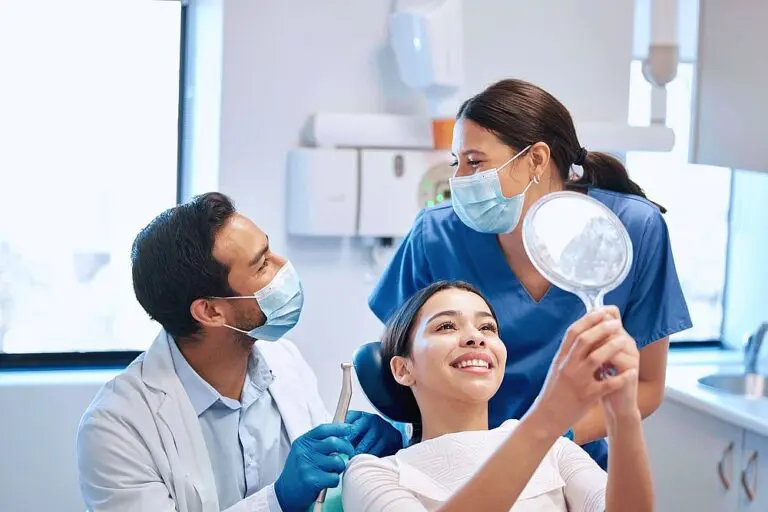 orthodontist assisting young woman checking her results - How To Get Braces Glue Off Teeth in New York City, NY