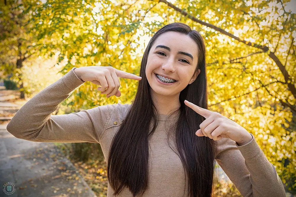 beautiful smiling girl showing metal braces teeth orthodontics dental theme - How to Clean Braces in New York City, NY 