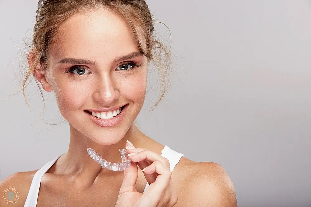 woman with invisalign clear aligners - How Does Invisalign Work in New York City, NY 