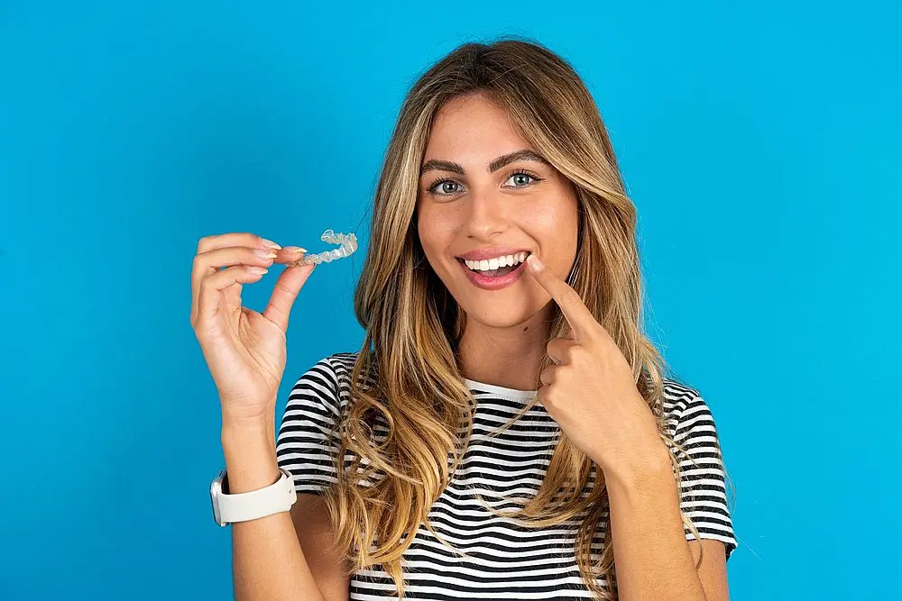 young beautiful blonde woman with invisalign clear aligners - How Does Invisalign Work in New York City, NY