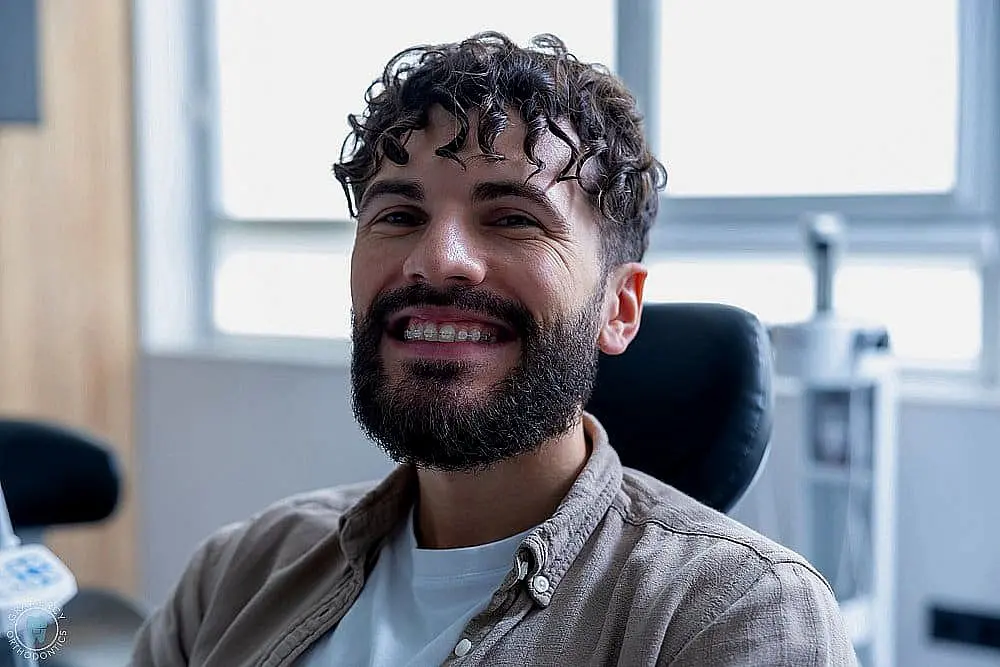 attractive smiling bearded man with clear braces - Clear Braces vs Metal Braces in New York CIty, NY 