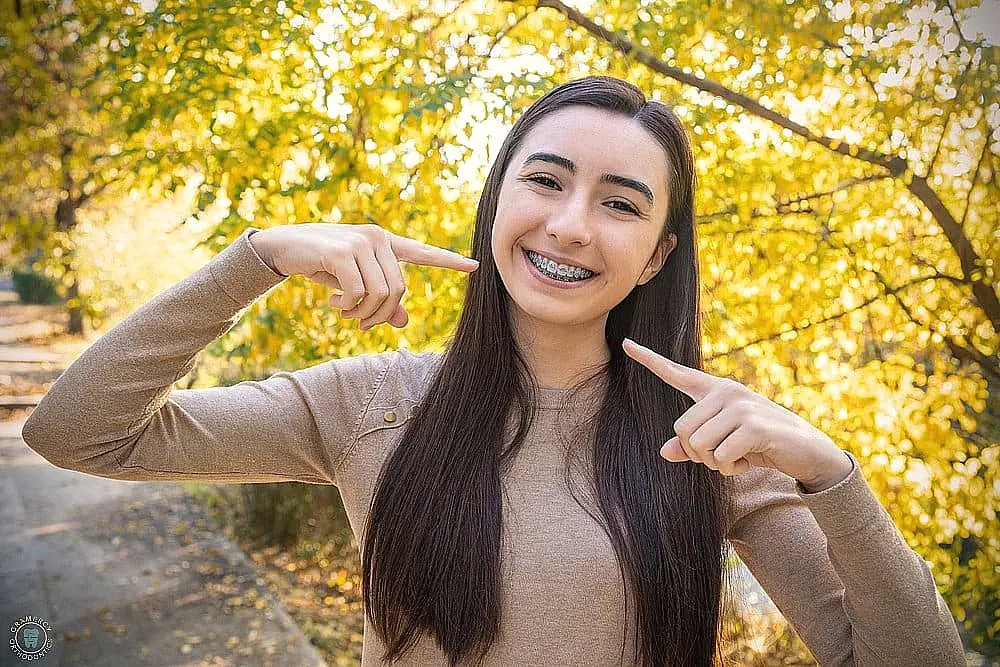 beautiful smiling girl showing metal braces teeth orthodontics dental theme - How to Clean Braces in New York City, NY