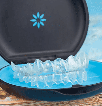Clear dental aligners in an open blue and black case, perfect for those considering an Invisalign Payment Plan in NYC